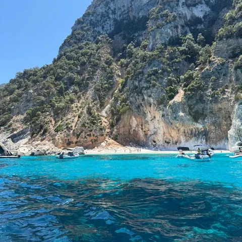 Boats below the cliffs at Cala Goloritzè