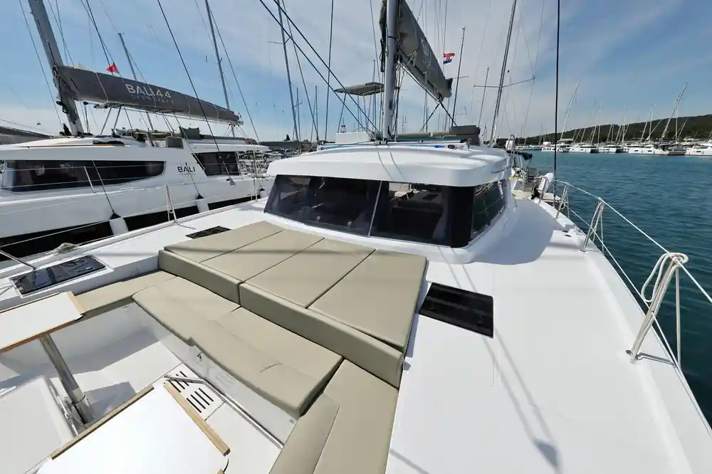 Close-up of white boat deck with cushions and mooring ropes