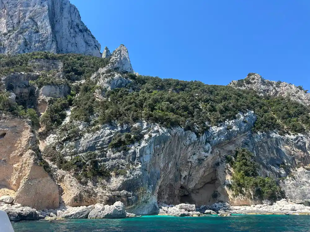 Dramatic limestone pinnacle in sea with clear turquoise water