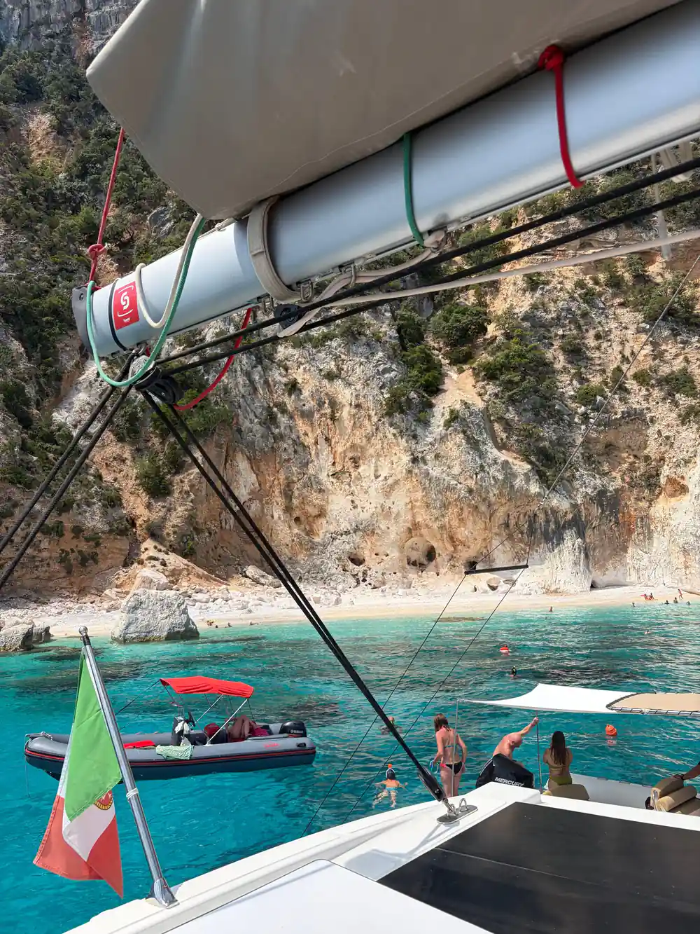 Italian flag and sailing rope with beach visible below