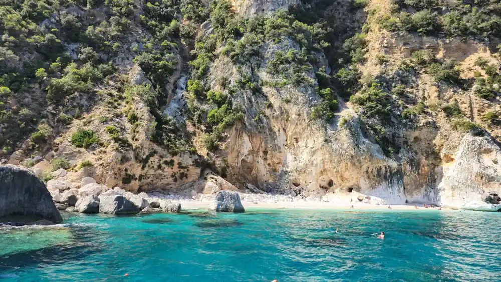 Limestone cliffs and white sand beach with turquoise water