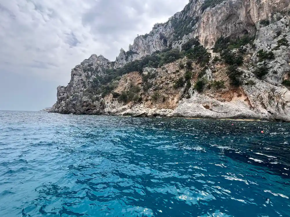 Rocky coastline with limestone cliffs meeting deep blue sea