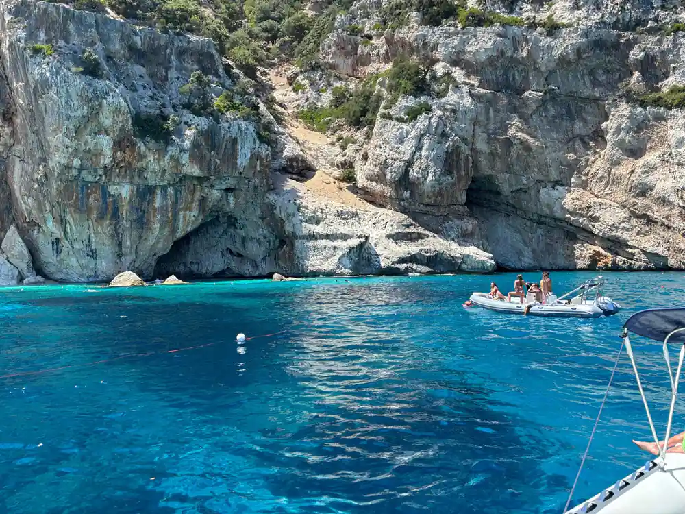 Rocky cove with turquoise water and small boat