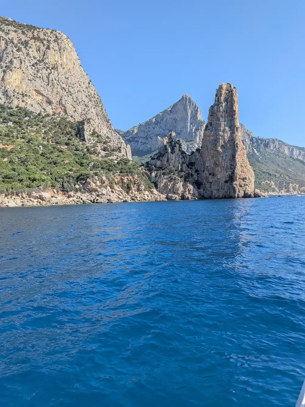 Rocky sea stacks and cliff formations rising from blue water