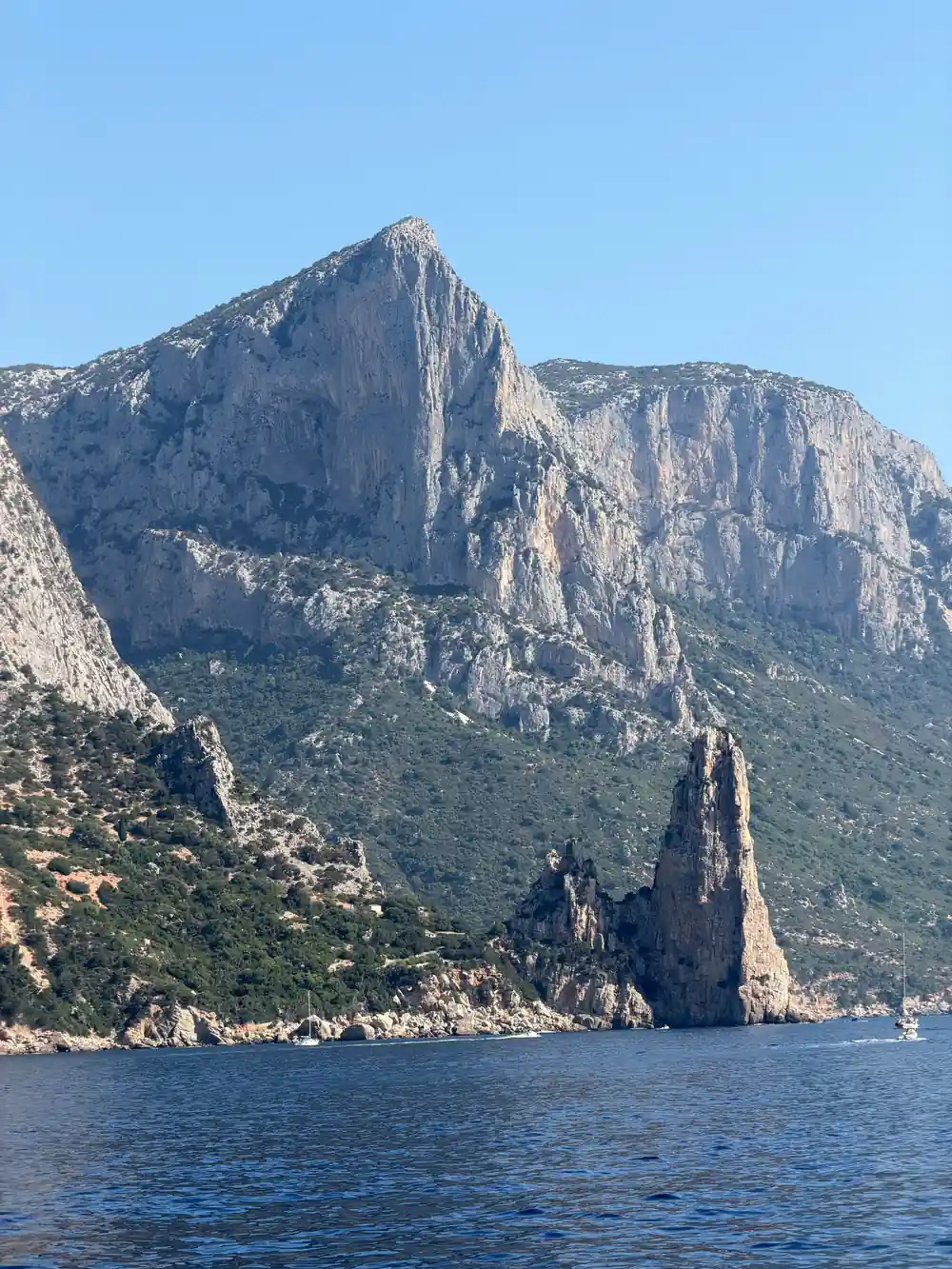 Two tall rocky sea stacks rising from turquoise water