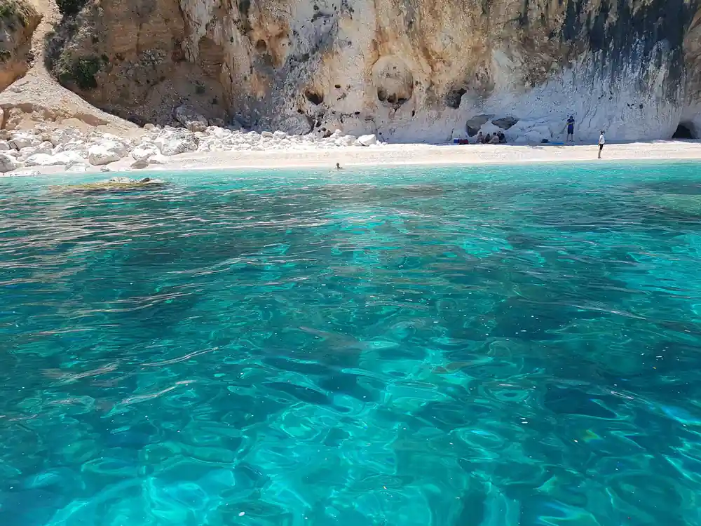 White limestone cliff meets pristine turquoise water and beach